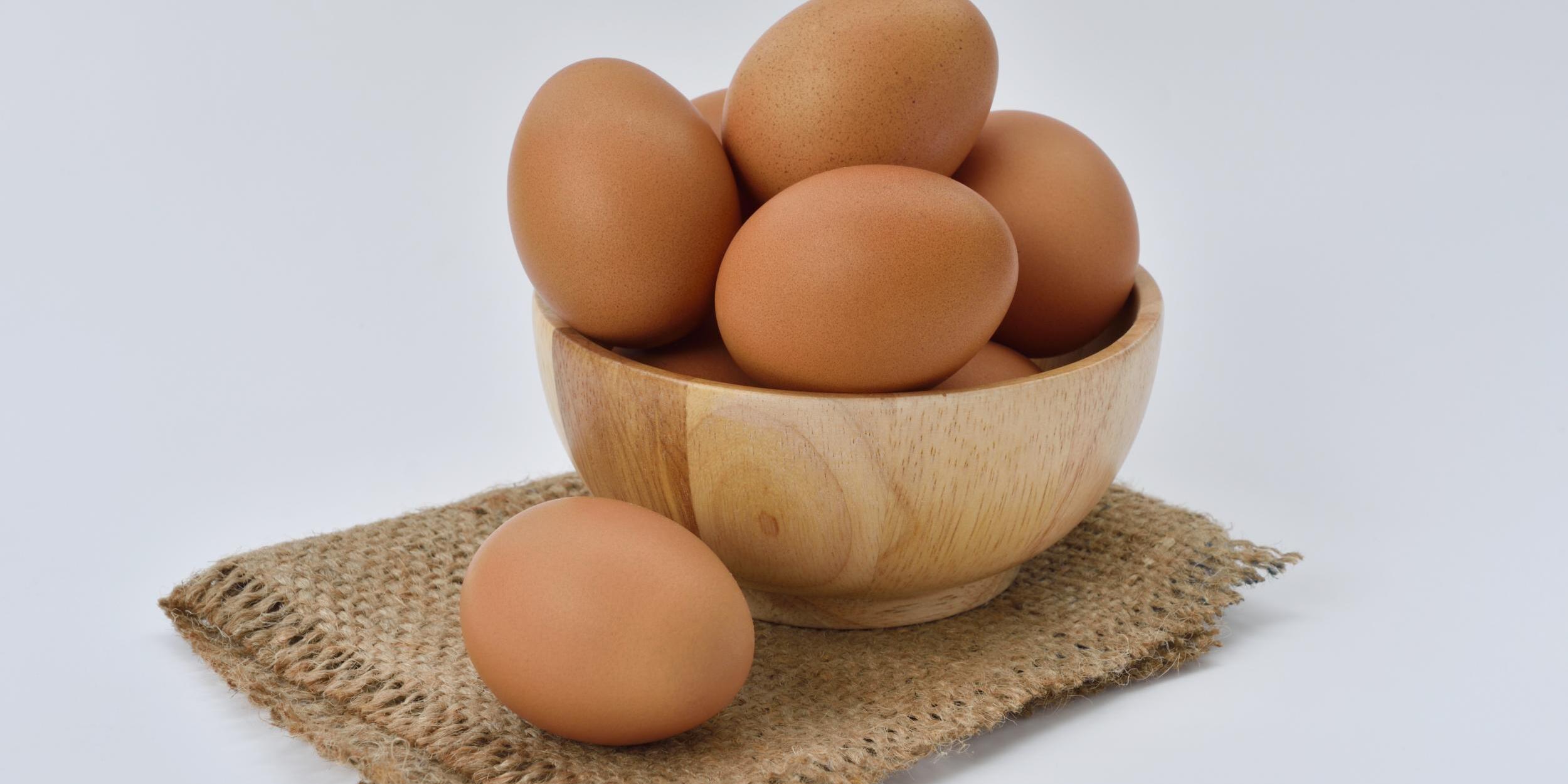 brown-eggs-on-brown-wooden-bowl-on-beige-knit-textile-162712